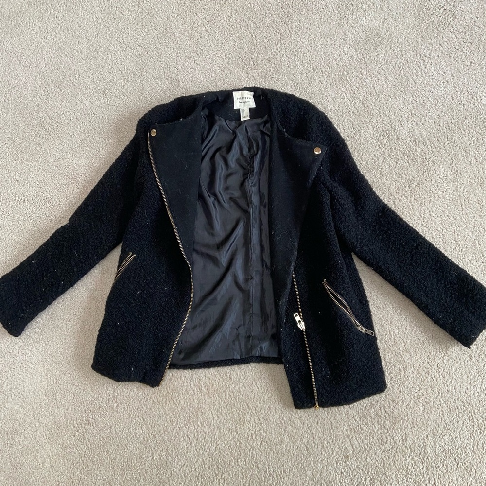 Black textured jacket with gold zipper detailing
